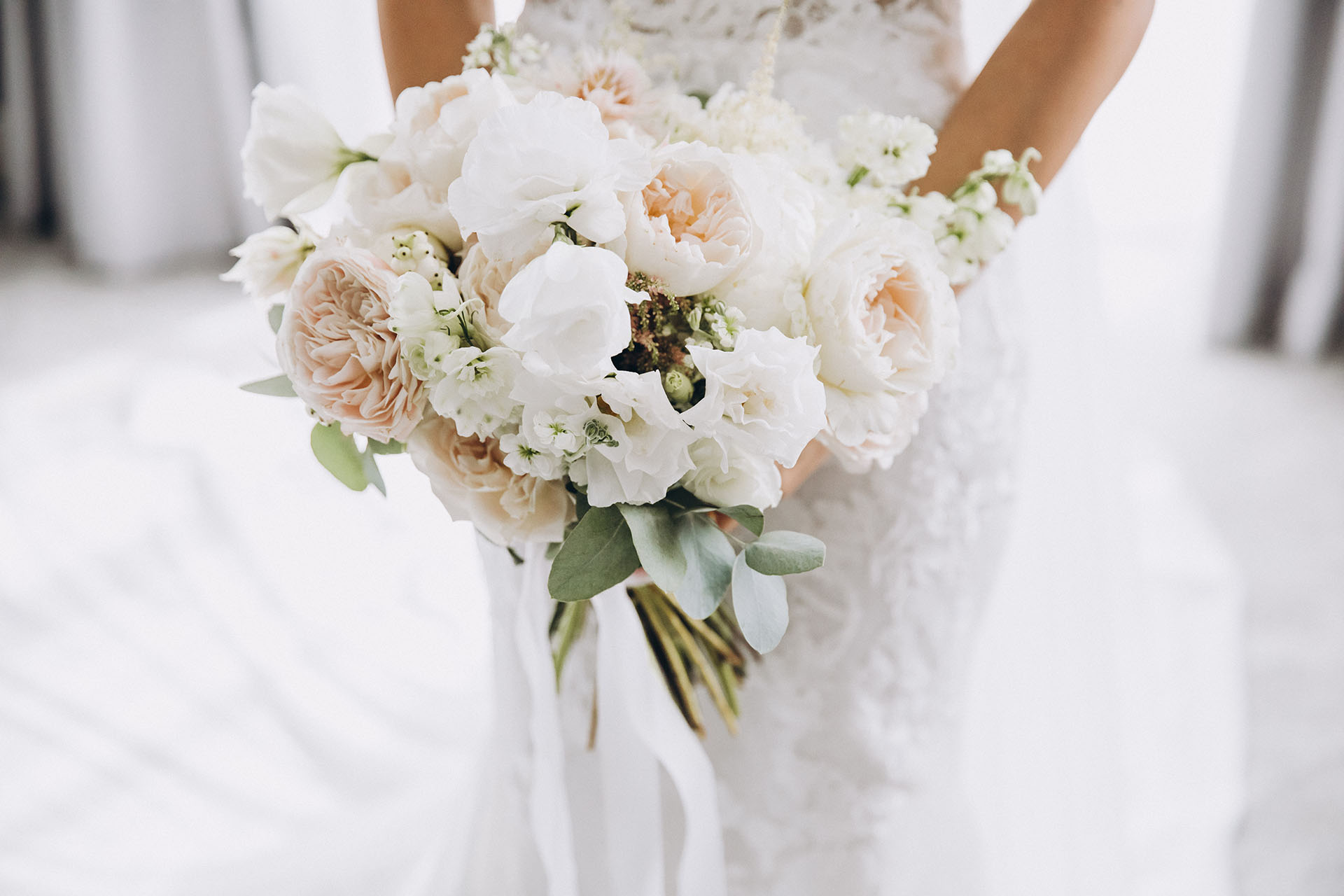 Young,Girl,In,A,White,Wedding,Dress,Holds,In,Her