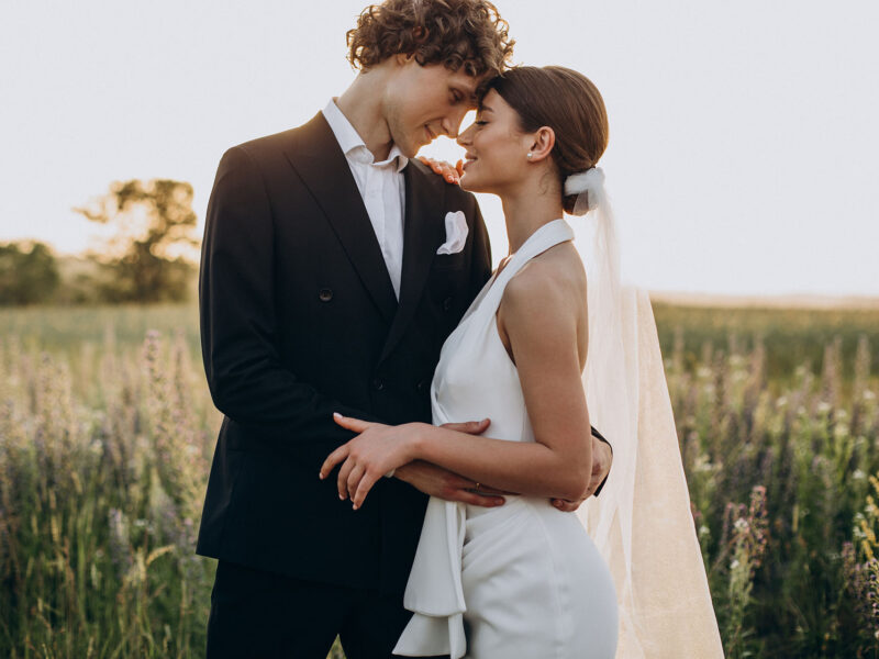 Young wedding couple together in field