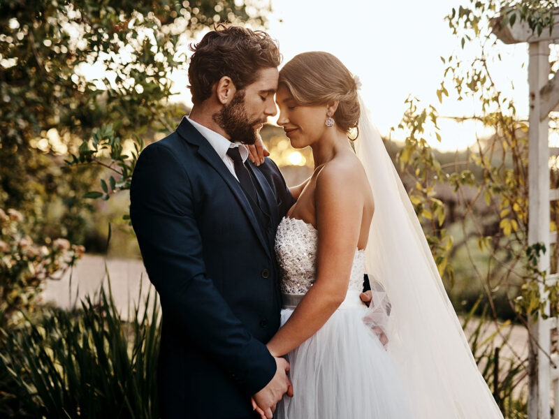 Wedding, love and bride with groom in garden for marriage, ceremony celebration and commitment. Romantic partners, trust and bridal couple hug, embrace and happy for romance, calm and peace in park